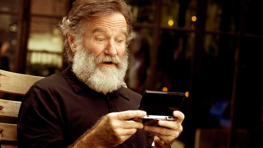 Robin Williams, probably playing Legend of Zelda on Nintendo DS